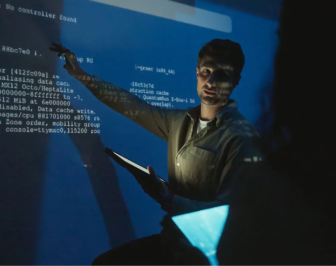 Person pointing at projected programming code