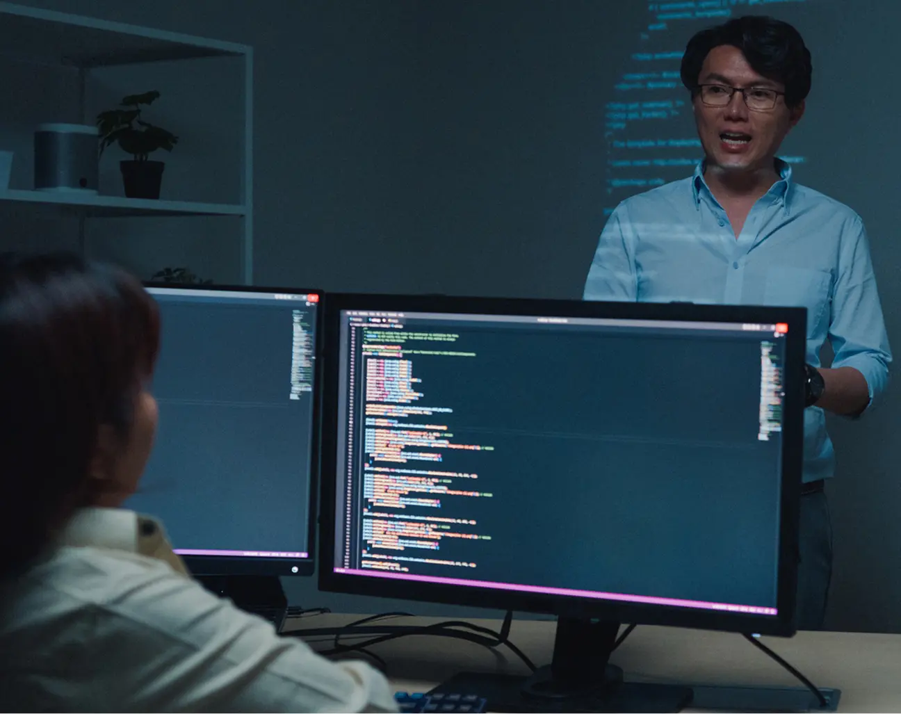 Developer explaining code on screens